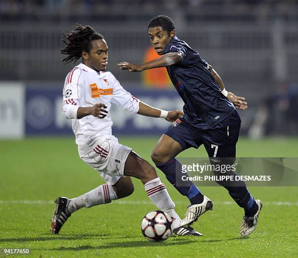 Lyon's Brazilian midfielder Michel Bastos fights for the ball with Debrecen's Honduran midfielder Luis Arcangel during the UEFA Champions League...