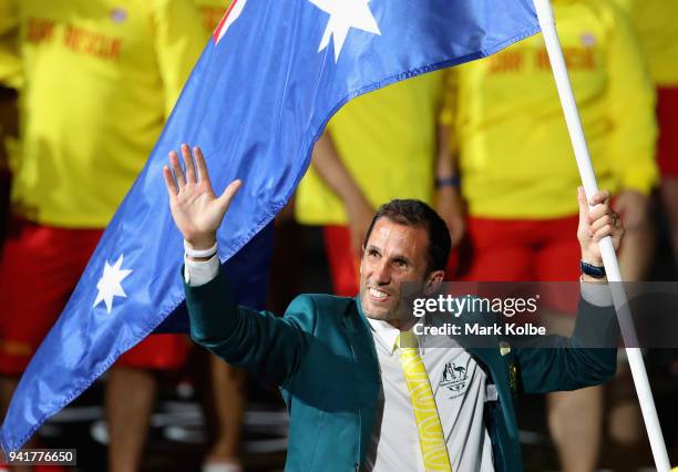 Mark Knowles, flag bearer of Australia arrives with the Australia team during the Opening Ceremony for the Gold Coast 2018 Commonwealth Games at...