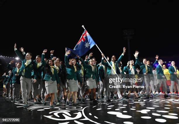 Mark Knowles, flag bearer of Australia arrives with the Australia team during the Opening Ceremony for the Gold Coast 2018 Commonwealth Games at...