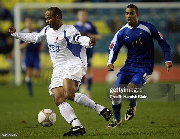 Danny Gordon of Staines runs on to the ball in front of Lewis Grabban of Millwall during the FA Cup sponsored by E.ON 2nd Round Replay match between...