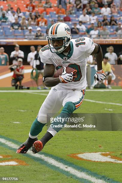 Ted Ginn, Jr. #19 of the Miami Dolphins carries the ball during a NFL game against the New England Patriots at Land Shark Stadium on December 6, 2009...