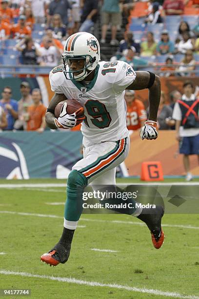 Ted Ginn, Jr. #19 of the Miami Dolphins carries the ball during a NFL game against the New England Patriots at Land Shark Stadium on December 6, 2009...