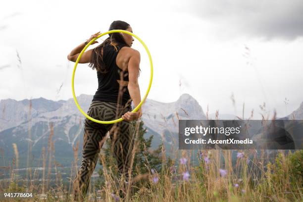 native american woman dances with hoops, in mountains - hooping stock pictures, royalty-free photos & images