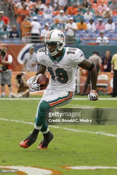 Ted Ginn, Jr. #19 of the Miami Dolphins carries the ball during a NFL game against the New England Patriots at Land Shark Stadium on December 6, 2009...