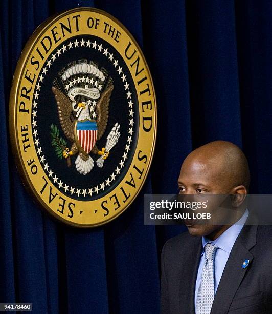 Reggie Love, personal aide to US President Barack Obama, talks with guests after Obama signed a presidential memorandum related to an announcment of...