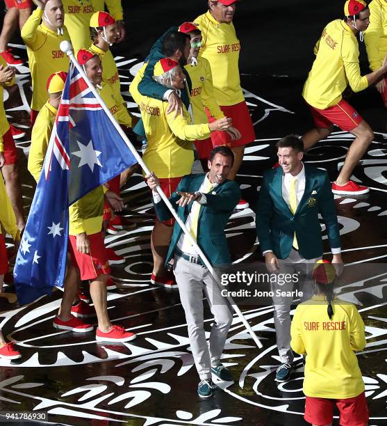 Australian flag bearer Mark Knowles carries the flag as the Australian team arrives to the stadium during the Opening Ceremony for the Gold Coast...