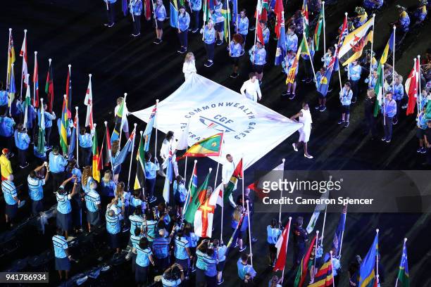 The Commonwealth Games Federation flag is carried into the stadium by Brendan Williams, Natalie Du Toit, Alison Shanks, Nicole Forrester, Colin...