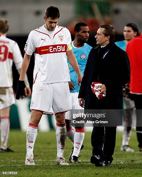 Manager Horst Heldt of Stuttgart talks to team captain Matthieu Delpierre after the UEFA Champions League Group G match between VfB Stuttgart and...