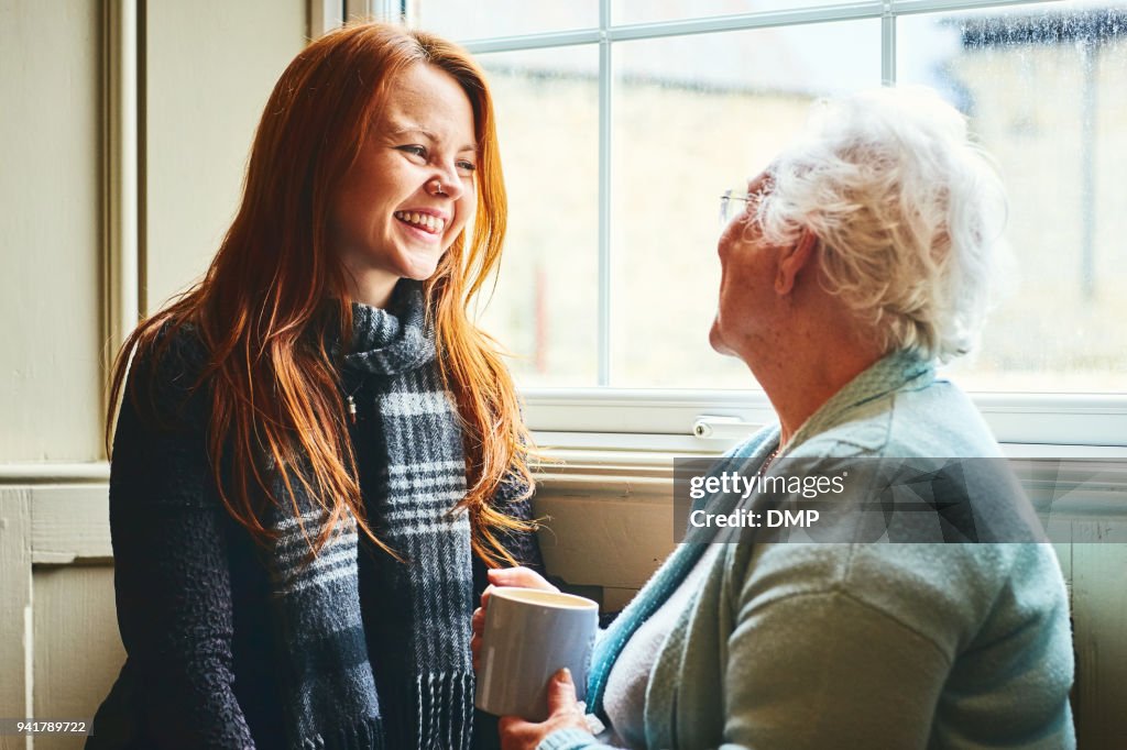 Pretty young woman talking with her mother