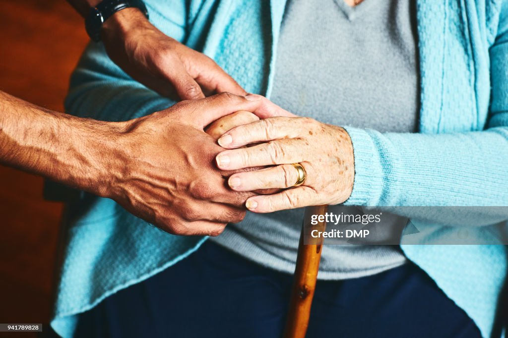 Home caregiver showing support for elderly patient.