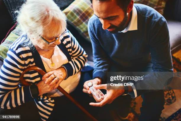 doctor explaining medicine dosage to senior patient - medicine dose stock pictures, royalty-free photos & images