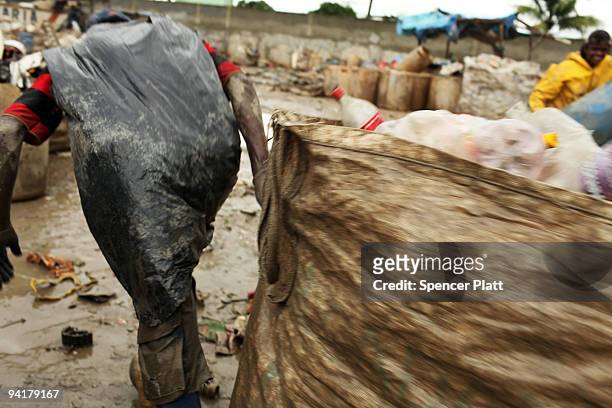 Man drags a bag of plastic bottles to be recycled at the Jardim Gramacho waste disposal site on December 9, 2009 in Jardim Gramacho, Brazil. Referred...