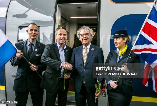 Netherlands politician Roger van Boxtel and Eurostar Chief Executive Mike Cooper shake hands after the arrival of a Eurostar train at Amsterdam...