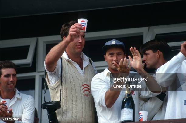 September 1991 Chelmsford, County Cricket Championship, Essex v Middlesex, Derek Pringle raises a cup of Champagne, alongside Nasser Hussein, as...