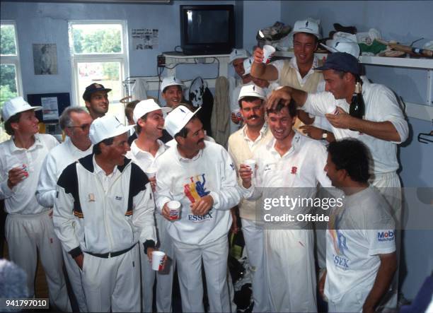 September 1991 Chelmsford, County Cricket Championship, Essex v Middlesex, Derek Pringle and Nasser Hussein pour champagne over Neil Foster as Essex...