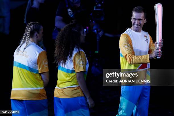 Australian cyclist cyclist Brad McGee carries the Queen's Baton in the opening ceremony of the 2018 Gold Coast Commonwealth Games at the Carrara...