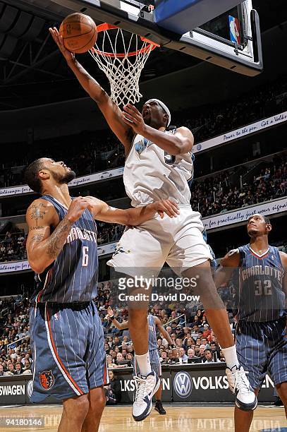 Dominic McGuire of the Washington Wizards goes to the basket against Tyson Chandler and Boris Diaw of the Charlotte Bobcats during the game on...