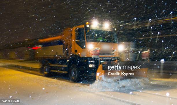 europe, austria, linz area, 2018: view of snow plow clearing road at night - linz stock-fotos und bilder