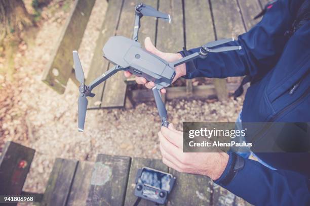 man holding small drone at sunlight close up - drone bee stock pictures, royalty-free photos & images