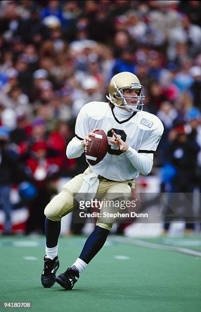 Rick Mirer of the Notre Dame Fighting Irish looks for a receiver during the Cotton Bowl game against the Texas A&M Aggies at the Cotton Bowl on...