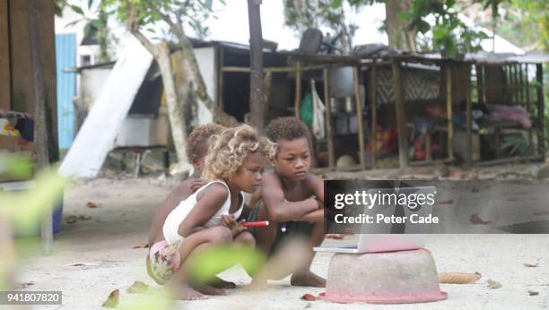 pacific island children looking at laptop - washing tub stockfoto's en -beelden