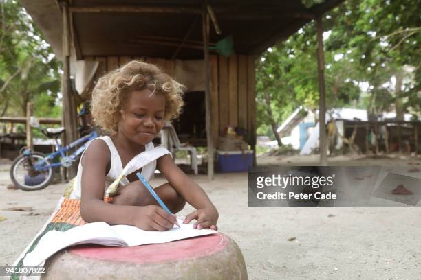 pacific island child doing homework - papua new guinea people stock pictures, royalty-free photos & images