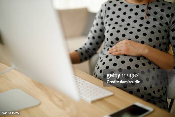 pregnant woman working from home office - pregnancy stock pictures, royalty-free photos & images