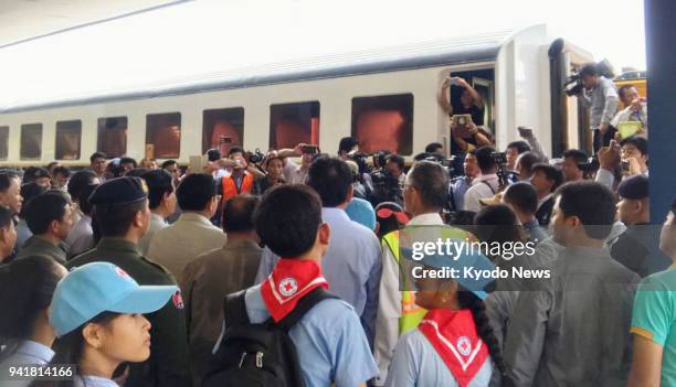 People gather at a railway station in Poipet, Cambodia, on April 4 as passenger trains begin operating between the border town and Sisophon. The...