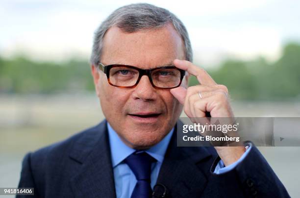 Martin Sorrell, chief executive officer of WPP Plc, adjusts his glasses as he poses for a photograph during a Bloomberg Television interview on the...