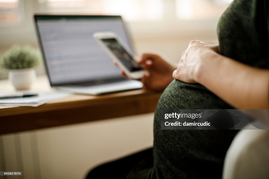 Pregnant woman using mobile phone