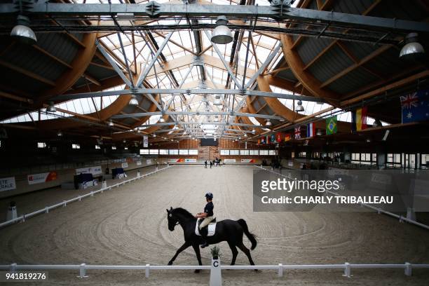 French para-Cavalier Jose Letartre rides 'Swing Royal' during a training session at the Pole International du Cheval on April 4, 2018 the day before...