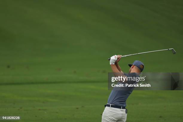 Kevin Chappell of the United States plays a shot on the practice range during a practice round prior to the start of the 2018 Masters Tournament at...