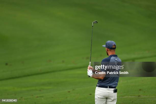 Kevin Chappell of the United States watches his shot on the practice range during a practice round prior to the start of the 2018 Masters Tournament...