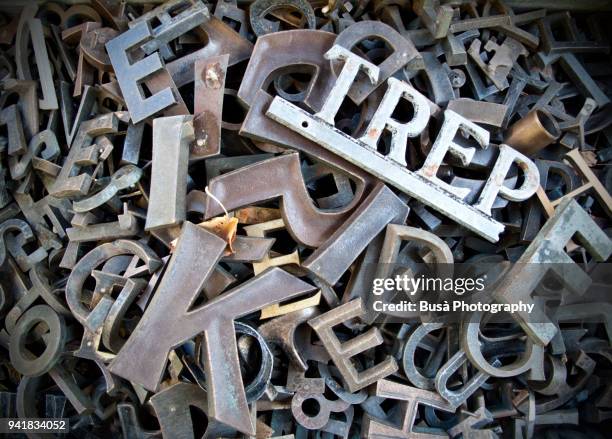 typescript metal letters seen in a flea market in berlin, germany - kunstdruck stock-fotos und bilder