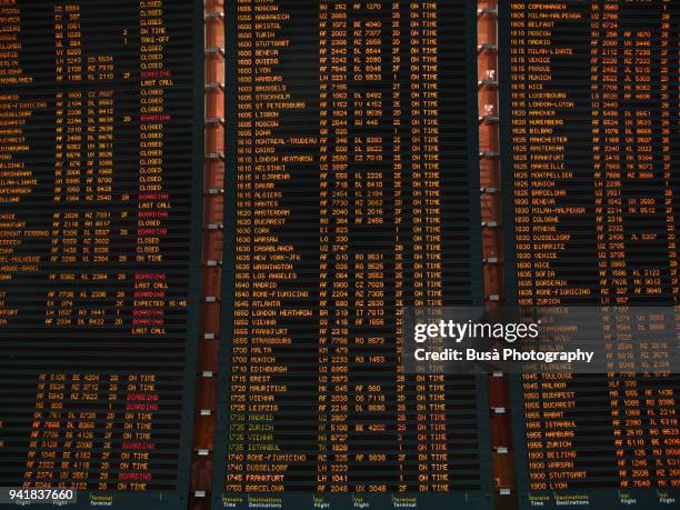 arrivals and departures timetable inside the charles de gaulle airport in paris - aeroport de paris stock pictures, royalty-free photos & images