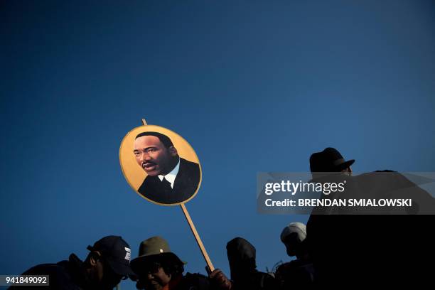 Woman holds a poster of Martin Luther King Jr. On the 50th anniversary of his assassination April 4, 2018 in Memphis, Tennessee.