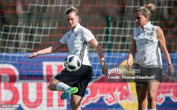 Alexandra Popp and Anna Blaesse of Germany play the ball during the Germany women's training session at Red Bull Akademie on April 4, 2018 in...