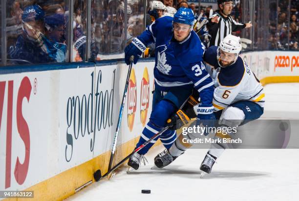 Auston Matthews of the Toronto Maple Leafs skates against Marco Scandella of the Buffalo Sabres during the first period at the Air Canada Centre on...