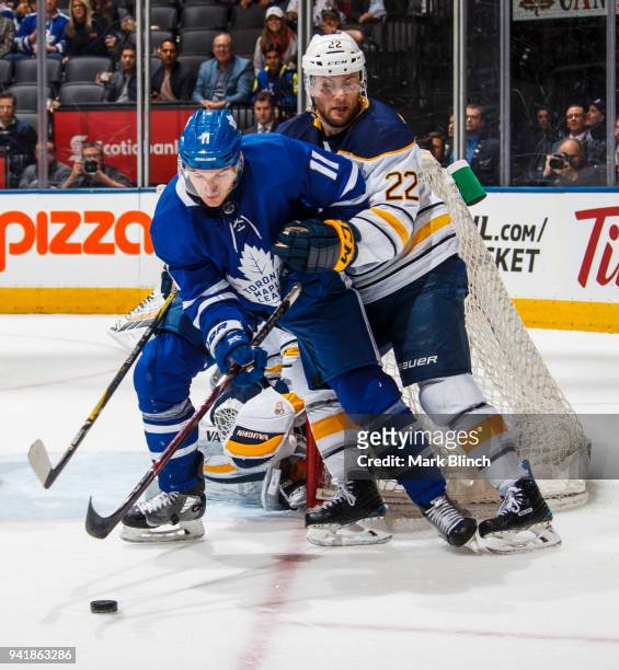 Zach Hyman of the Toronto Maple Leafs battles with Johan Larsson of the Buffalo Sabres during the third period at the Air Canada Centre on April 2,...