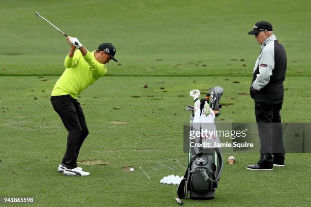 Coach Butch Harmon watches Rickie Fowler of the United States on the practice range during a practice round prior to the start of the 2018 Masters...
