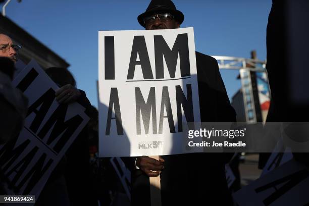 Luis Holmes holds 'I Am A Man' signs, in reference to the sanitation workers strike in 1968, as he participates during an event to mark the 50th...