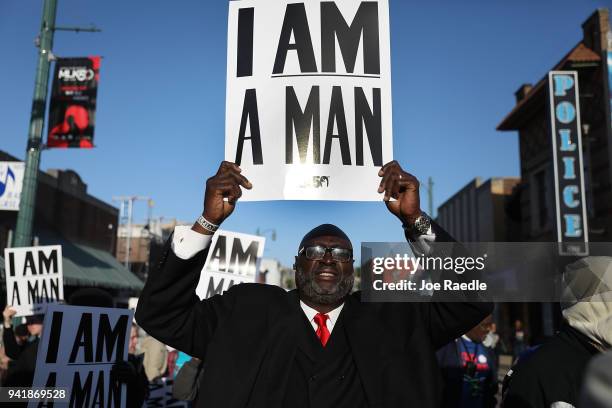 Michael Jenkins holds 'I Am A Man' signs, in reference to the sanitation workers strike in 1968, as he participates during an event to mark the 50th...