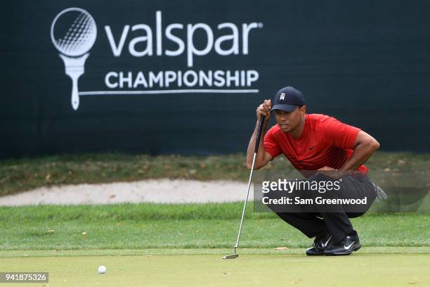 Tiger Woods looks over a putt on the 12th green during the final round of the Valspar Championship at Innisbrook Resort Copperhead Course on March...