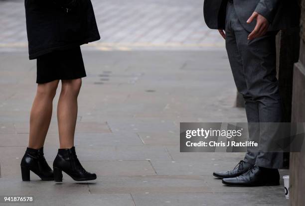 Woman and man talk in the street as the deadline nears for companies to report their gender pay gap on April 4, 2018 in London, England. The British...