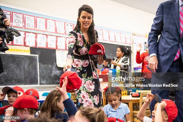 Boston Red Sox Foundation Board Member Linda Pizzuti Henry distributes hats to students hat donation event at the Hurley School on April 4, 2018 in...