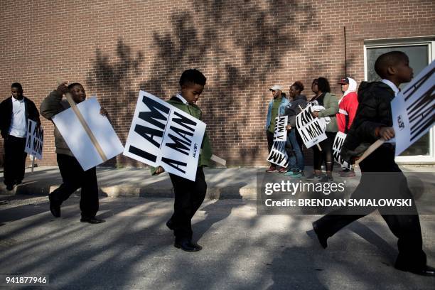 People arrive to march to commemorate the 50th anniversary of the assassination of Martin Luther King Jr. April 4, 2018 in Memphis, Tennessee. / AFP...