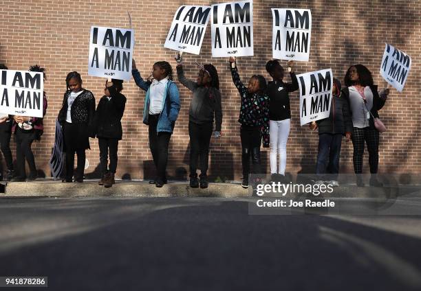 Children from Promise Academy Spring Hill hold 'I Am A Man' signs, in reference to the sanitation workers strike in 1968, as they participate in an...