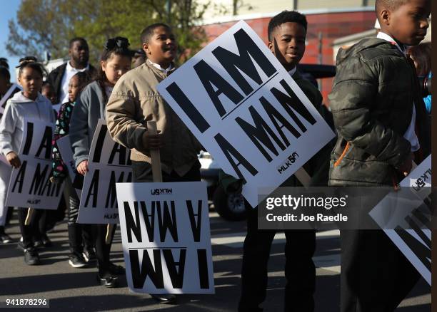 Children from Promise Academy Spring Hill hold 'I Am A Man' signs, in reference to the sanitation workers strike in 1968, as they participate in an...