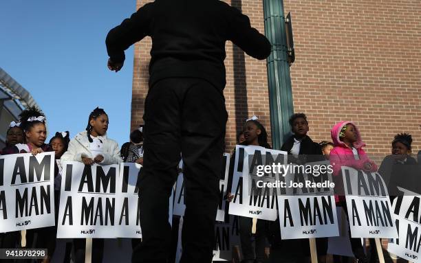 Children from Promise Academy Spring Hill hold 'I Am A Man' signs, in reference to the sanitation workers strike in 1968, as they participate in an...