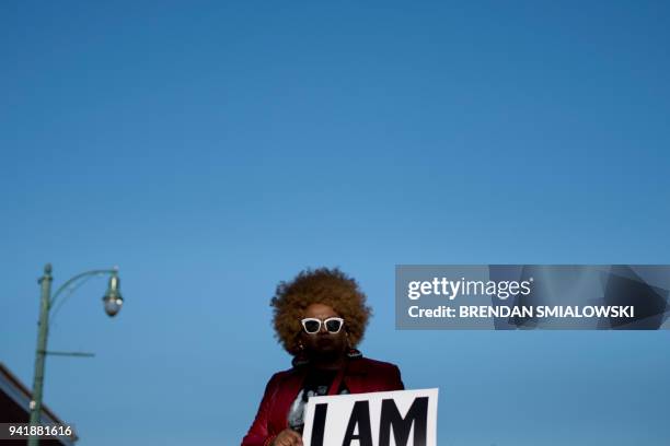 Woman holds a sign honoring the sanitation strikers on the 50th anniversary of the assassination of Martin Luther King Jr. April 4, 2018 in Memphis,...